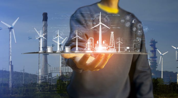 Man holding digital tablet for developing clean energy such as wind energy for energy sustainability.