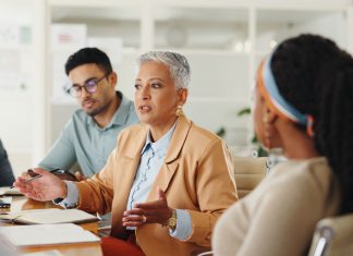 Nuance In, Noise Out: Helping your Team Maintain Focus Amidst Uncertainty Senior, woman or business people in meeting with talking in teamwork for creative decision making.