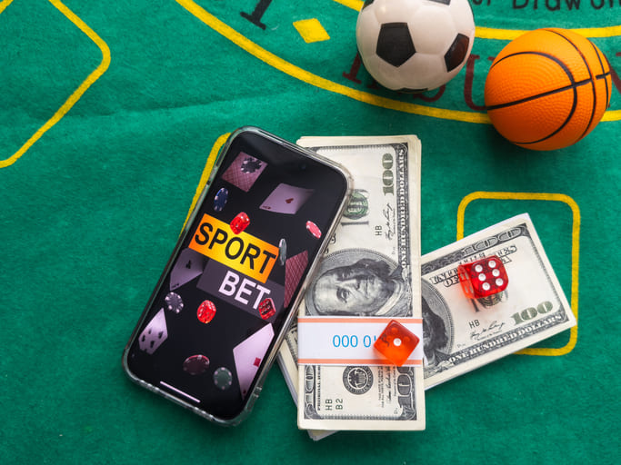 iStock-2159319124 (1) Sports betting app with dollars