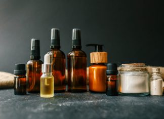 Cosmetics packaging. Set of different cosmetic bottles of cream or serum on a ceramic tray.