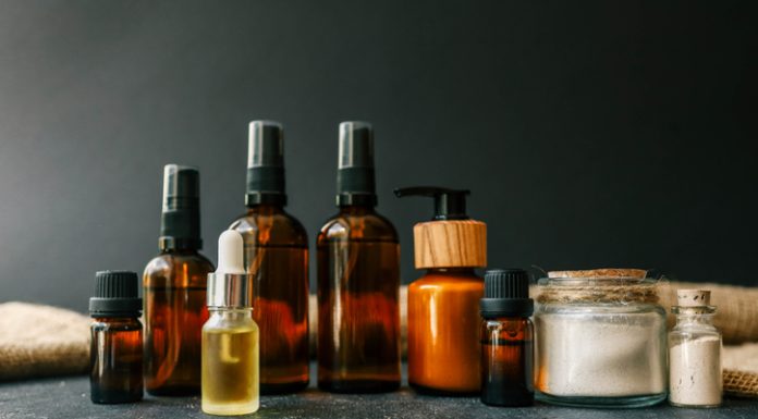 Cosmetics packaging. Set of different cosmetic bottles of cream or serum on a ceramic tray.