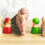 How to Navigate Office Politics Like A Pro Red and green wooden figures teams against opponent or enemy. Office politics concept