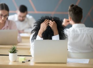 From Burnout to Breakthrough: Why Resilience Matters and How to Create It Frustrated african-american woman feeling burnout in shared office with laptop
