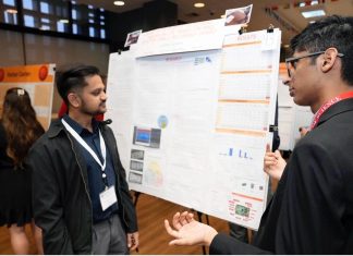 Two indians discussing a presentation related to AI healthcare