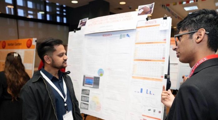 Two indians discussing a presentation related to AI healthcare