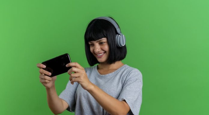 Navigating the 2025 Regulatory Landscape: How Europe’s Casino Industry Is Adapting to Change Smiling young brunette caucasian woman on headphones holds and looks at phone