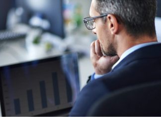 Professional Pitch Deck consultant looking at the statistics on laptop screen