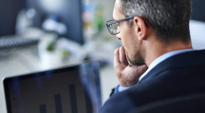 Professional Pitch Deck consultant looking at the statistics on laptop screen