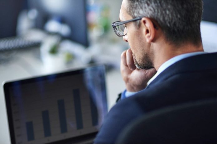 Professional Pitch Deck consultant looking at the statistics on laptop screen