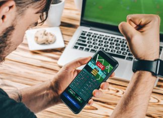 Lucky man celebrating victory after making bets on ICCWIN using gambling mobile application on his phone.