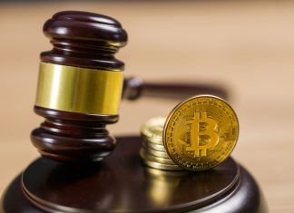 Photo of Bitcoin Regulation. BTC crypto coin and gavel on a desk.