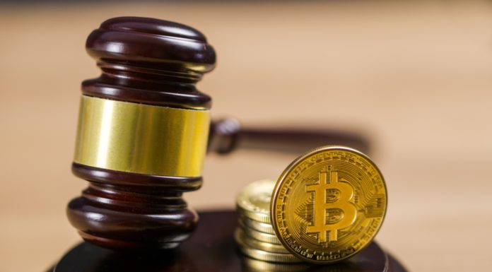 Ripple Settlement Signals Regulatory Shift Photo of Bitcoin Regulation. BTC crypto coin and gavel on a desk.