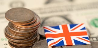 Loan providers in UK. United Kingdom Flag on coins background