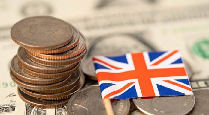 Loan providers in UK. United Kingdom Flag on coins background
