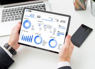 How Performance Metrics Can Help Financial Advisors Grow Their Practice Financial advisor examining the graph on tablet