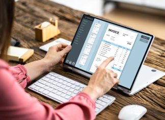Is Your Business Missing Out on the Benefits of AP Software? Woman working on computer with invoice software