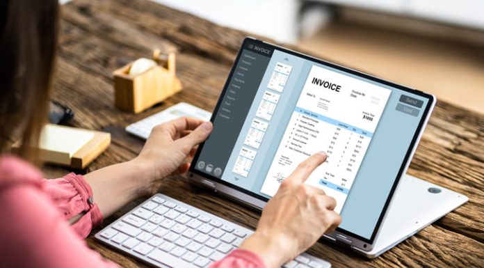 Is Your Business Missing Out on the Benefits of AP Software? Woman working on computer with invoice software