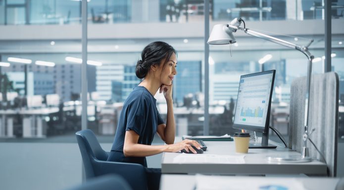 Spynn’s Matteo Ferretti Predicts Top 5 PR Trends That Will Dominate 2025 In Big Corporate Office: PR Business Manager Using Computer, Businesspeople and Experts Working Around Her, Analysing Statistics, Commerce Data, Marketing Plans.