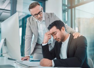 Business leader comforting employee with climate anxiety