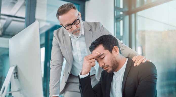 Business leader comforting employee with climate anxiety