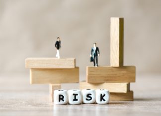 You Must Innovate Your Governance too! The Risk for Startups and SMEs Risk business and SME concept, business man stands on wooden blocks. risk control and managment idea