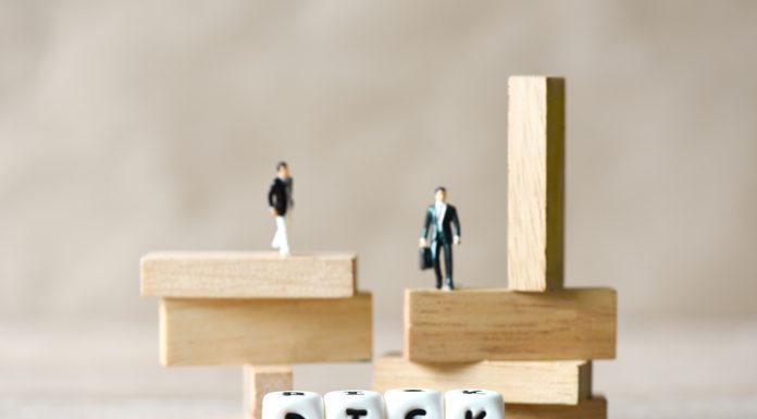 You Must Innovate Your Governance too! The Risk for Startups and SMEs Risk business and SME concept, business man stands on wooden blocks. risk control and managment idea