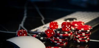 Poker chips lie on the keyboard. Online casino and gamification concept