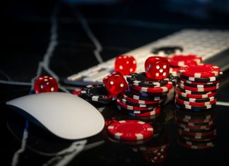 Poker chips lie on the keyboard. Online casino and gamification concept
