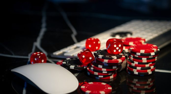 Poker chips lie on the keyboard. Online casino and gamification concept