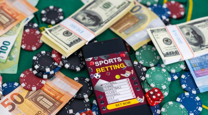 How Syndicates Influence Odds in Major Sportsbooks Gold inscription Sports Betting on a smartphone on the background of the stadium.