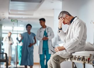 Doctor in the healthcare industry feeling tired from and emotional labor