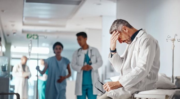 Doctor in the healthcare industry feeling tired from and emotional labor