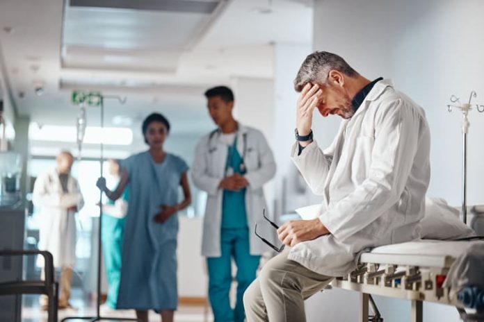 Doctor in the healthcare industry feeling tired from and emotional labor