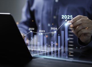 Businessman analyzes the graph of trend market growth in 2025 and plans business growth and profit increase in the year 2025.