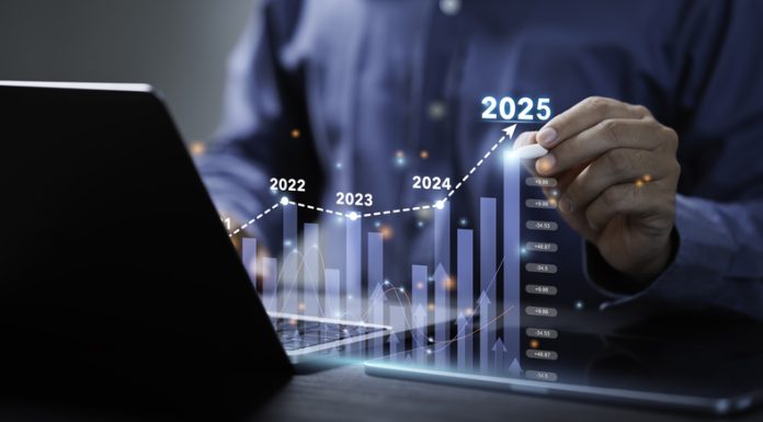 Businessman analyzes the graph of trend market growth in 2025 and plans business growth and profit increase in the year 2025.