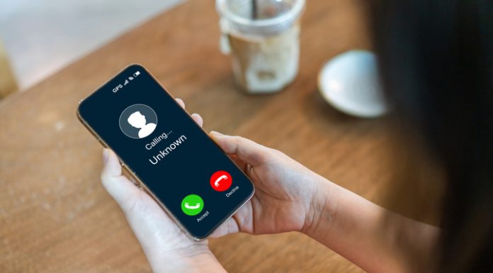 Human use smartphone with incoming call from unknown numbers