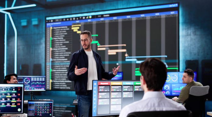 Multiracial executive training room presenting data