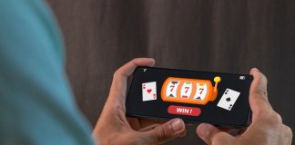 Man winning jackpot on online casino app on a smartphone. Online casino gambling development concept.