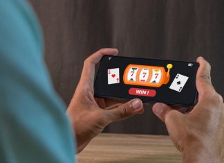 Man winning jackpot on online casino app on a smartphone. Online casino gambling development concept.