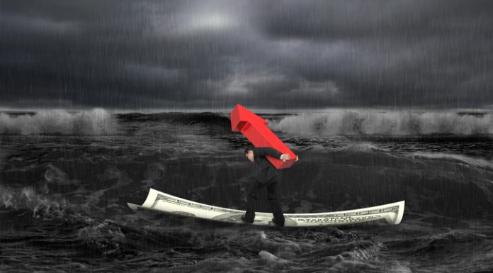 Businessman carrying red arrow up sign on money boat in dark stormy sea with waves coming. Growing business concept