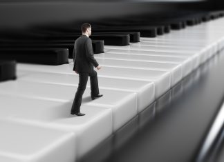 The Business Symphony: Management Lessons from Music Creation Side view of young businessman walking on abstract piano keys. Music, show business concept.