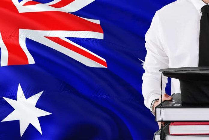 iStock-1131724282 (1) Holding books and graduation cap over Australia flag