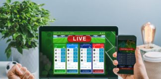 Man using his laptop and smartphone for making research on bets online at bookmaker's website and mobile application.