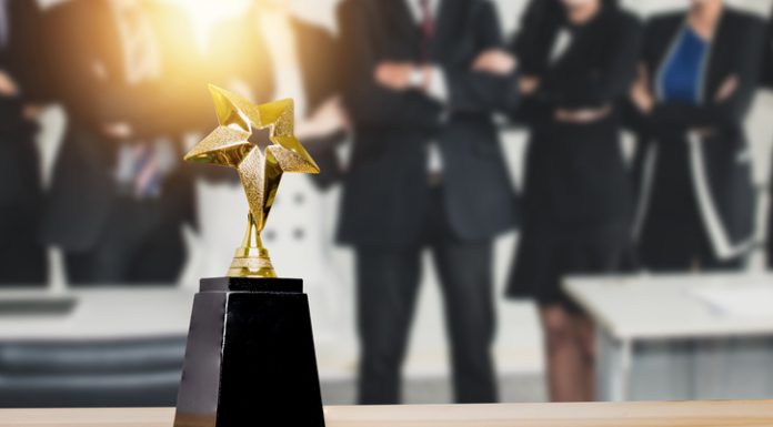 celebration of group successful businesspeople celebrate in success business holding golden award on soft blue background
