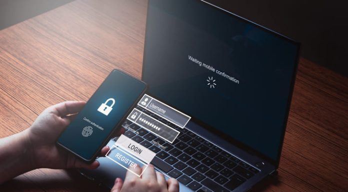 Person typing pin to log in