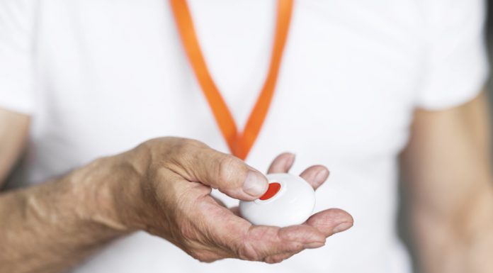 Why Personal Alarms for Lone Workers Are More Important Than Ever Elderly man pressing alarm button for emergency hung on his chest