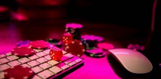 Online casino. Online poker. On the table there are game pieces and dice next to the keyboard