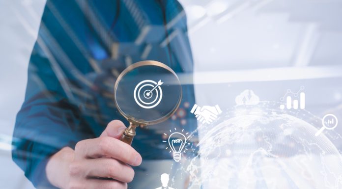 Business development businessman using Magnifier glass focus to target icon which for planning development leadership, visibility and customer target group