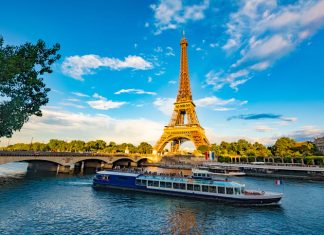 Europe’s Tourism Boom: Trends, Impacts, and Opportunities The main attraction of Paris and all of Europe is the Eiffel tower in the rays of the setting sun on the bank of Seine river with cruise tourist ships. Promoting tourism