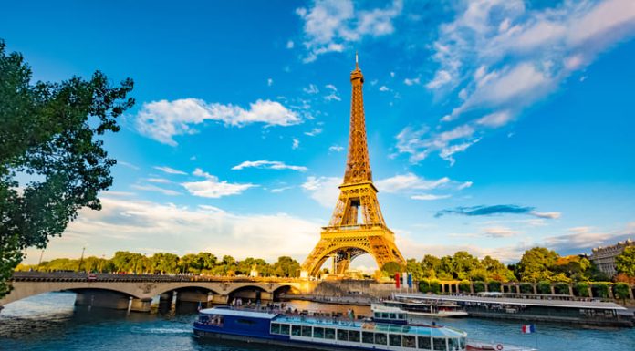Europe’s Tourism Boom: Trends, Impacts, and Opportunities The main attraction of Paris and all of Europe is the Eiffel tower in the rays of the setting sun on the bank of Seine river with cruise tourist ships. Promoting tourism